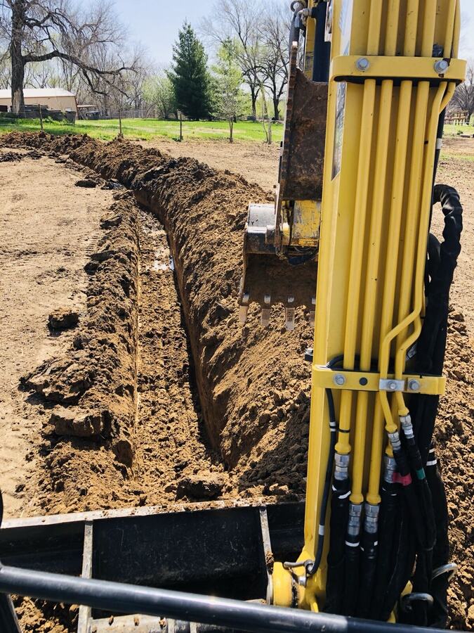 Excavating a drainage trench